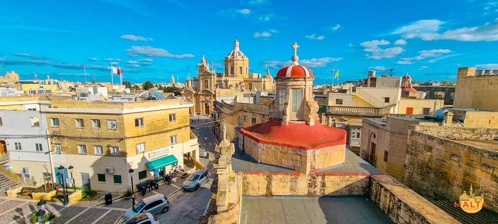 An aerial view of the Rabat square, featuring the Basilica of St. Paul and St. Cathaldus Church. 