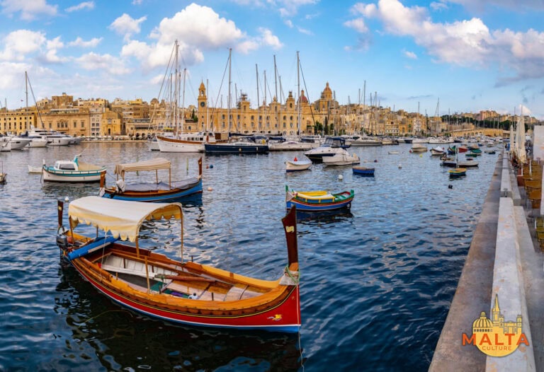 A stunning view of the Three Cities Harbour, featuring colourful luzzu boats, the Maritime Museum and other old buildings.