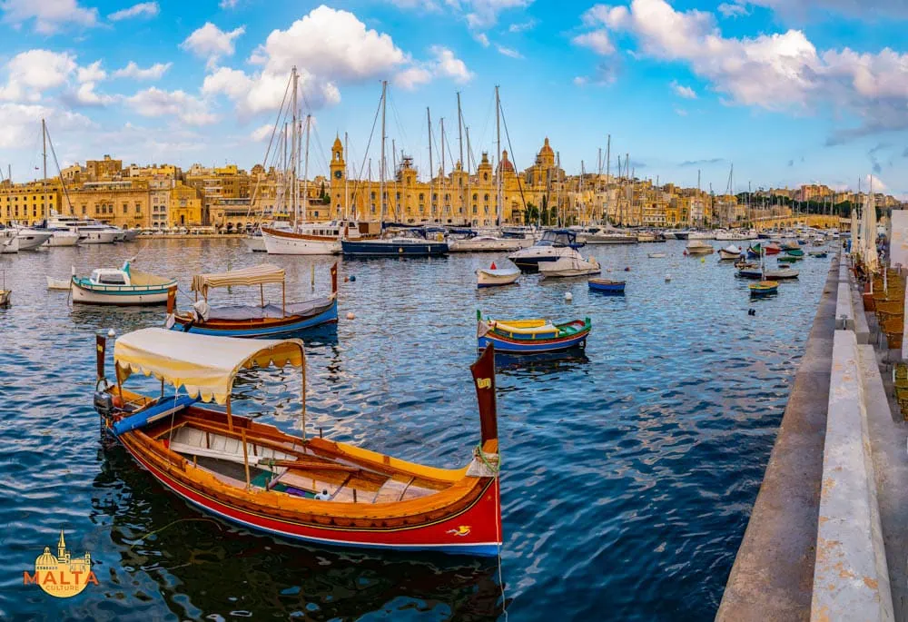 A stunning view of the Three Cities Harbour, featuring colourful luzzu boats, the Maritime Museum and other old buildings.
