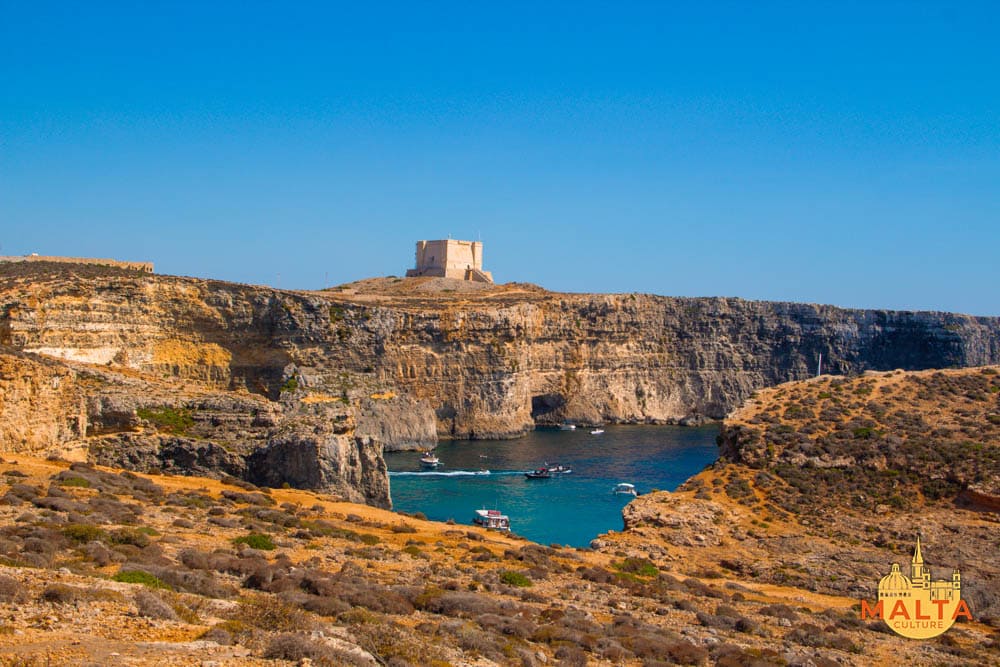 The stunning Crystal Lagoon and the surrounding cliffs of Comino.