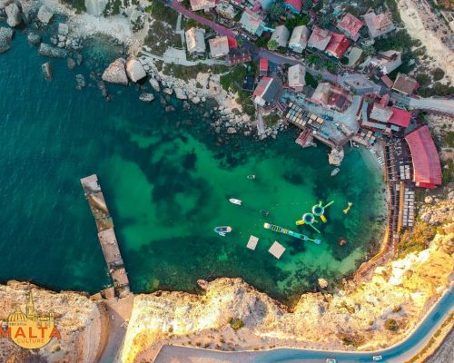 Drone shot of Anchor Bay and Popeye Village in Malta.